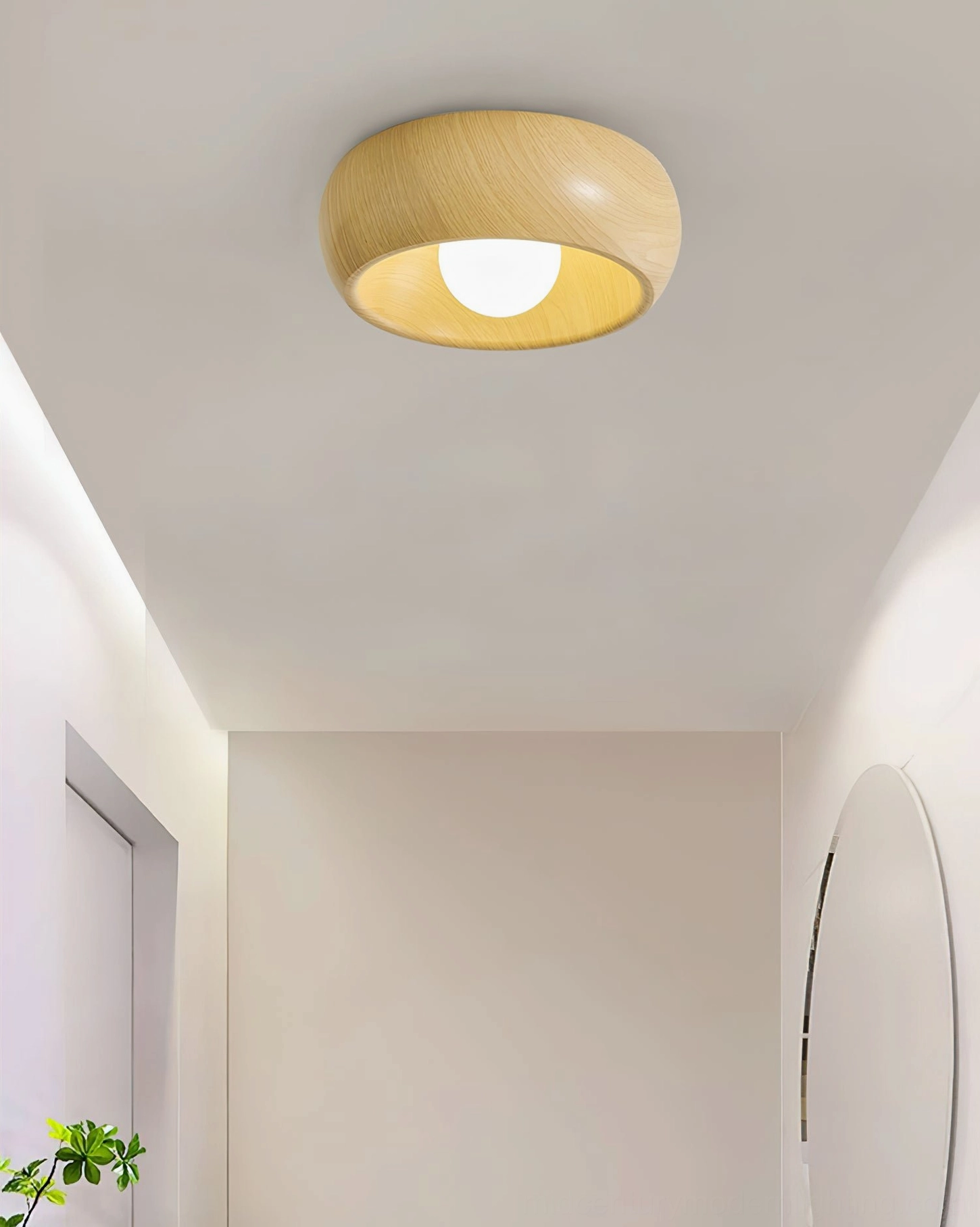 Natural wood Alana ceiling light fixture in soft minimalist hallway with round wall mirror