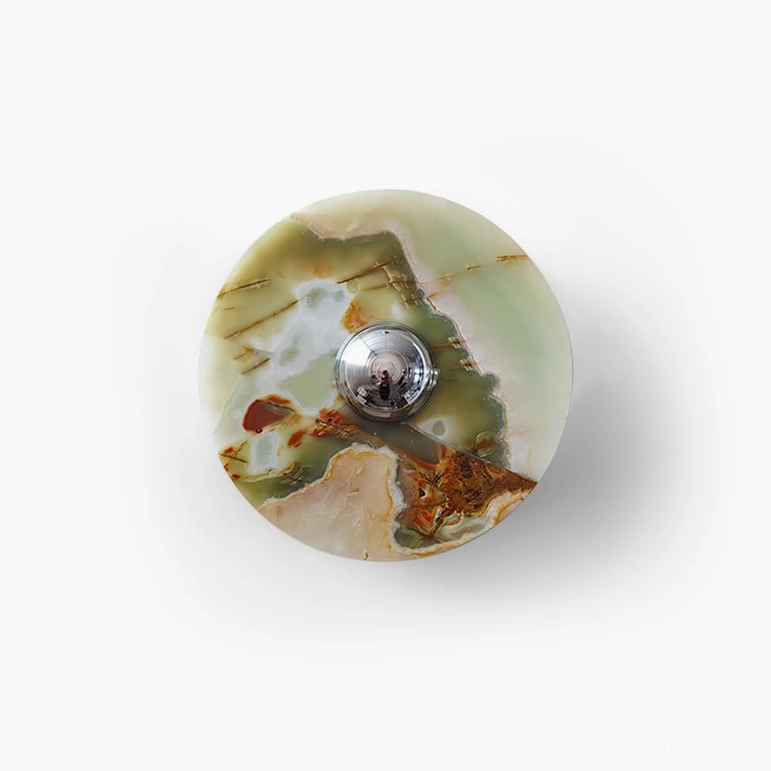 Alba round marble wall light slightly angled view on white studio background displaying symmetrical natural veining pattern