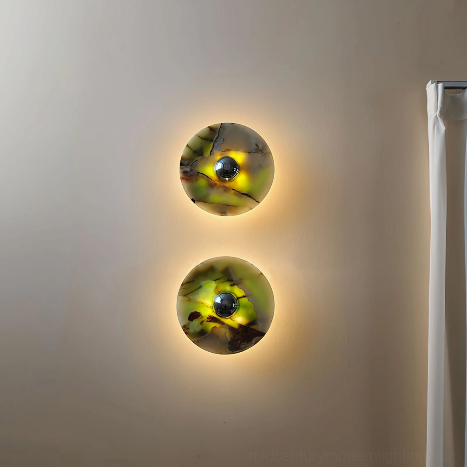 Alba marble wall sconce illuminated in bathroom setting showing warm backlit glow through translucent stone creating ambient spa atmosphere