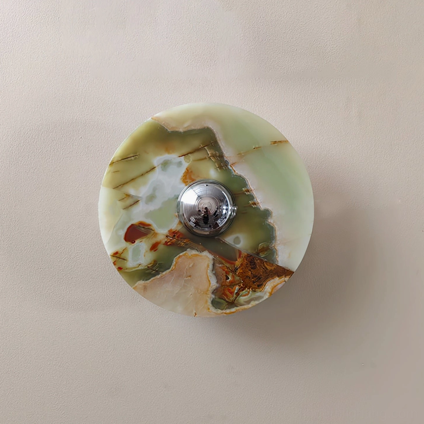 Alba marble wall fixture close-up displaying unique green-brown-white natural stone pattern and mineral composition