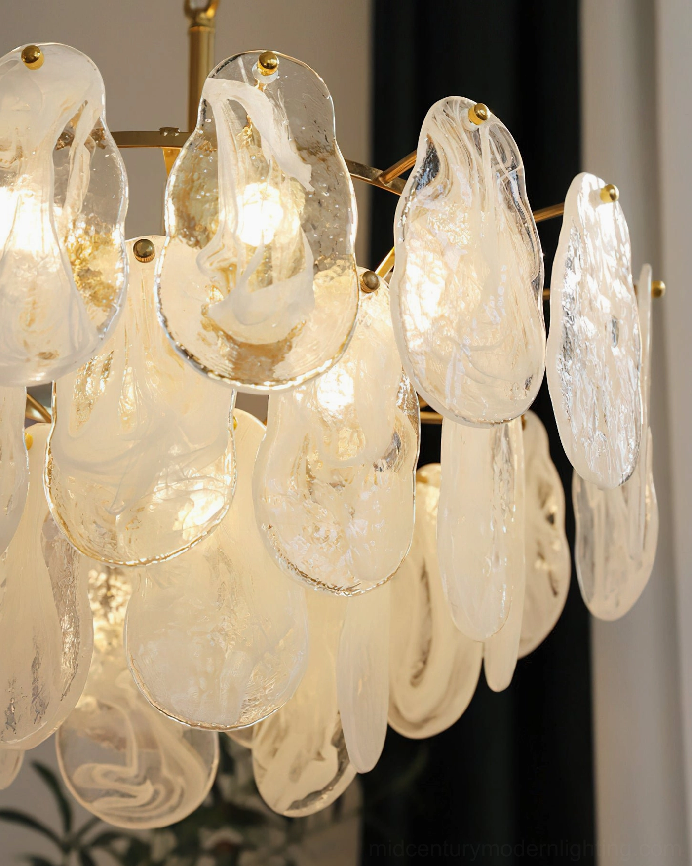 Alessia Glass Chandelier close-up lit detail, glowing internal bulbs, marbled teardrop glass, gold brass