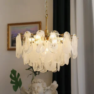 Alessia Glass Chandelier lit in luxury home interior, warm glow from brass frame and marbled glass shades