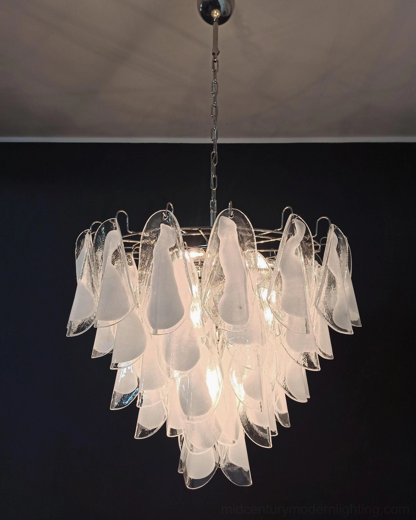 Aletta chandelier hanging illuminated minimalist ceiling setup warm ambient glow