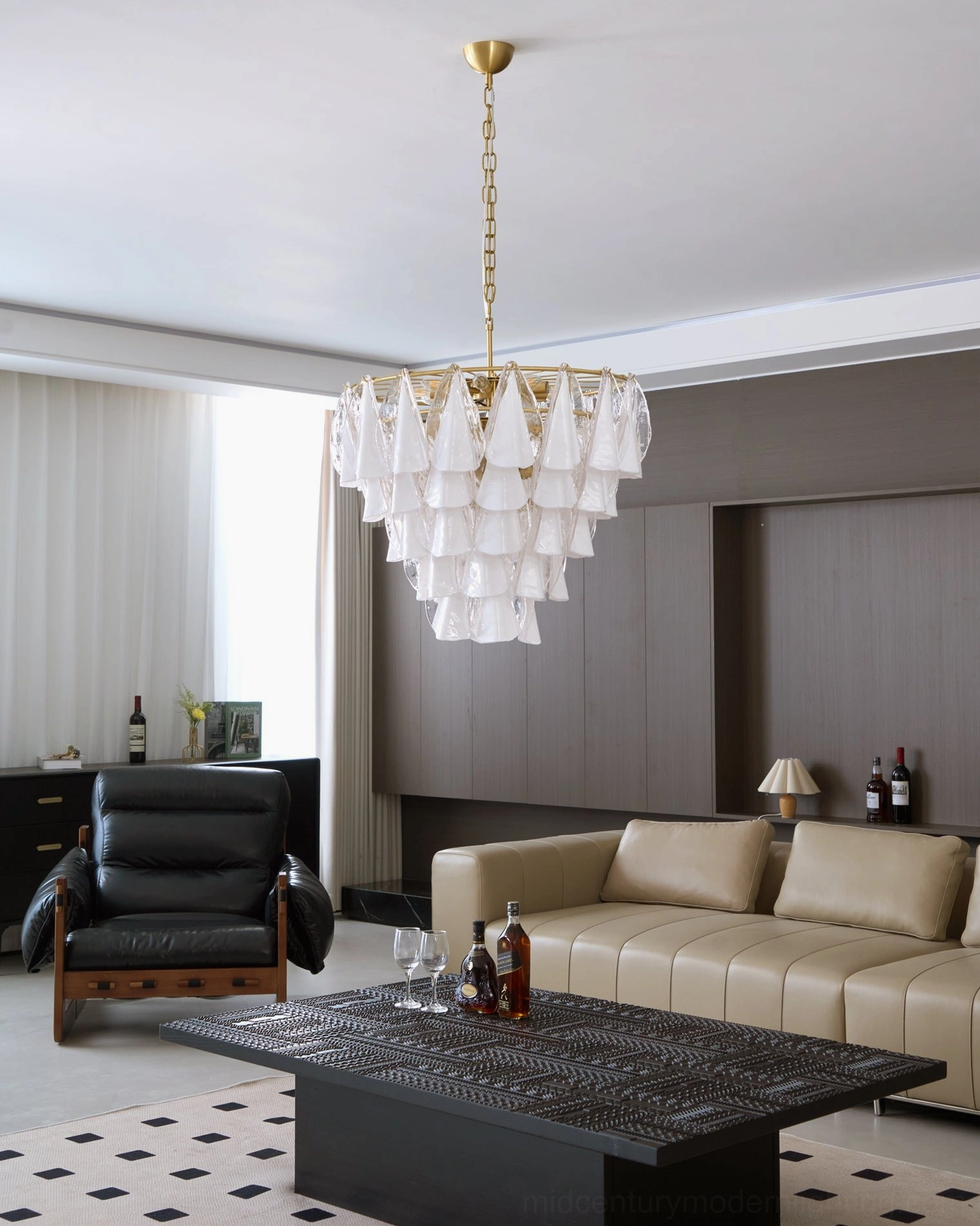 Alira glass chandelier in contemporary luxury home with beige sofa and black leather chair, side wide-angle view