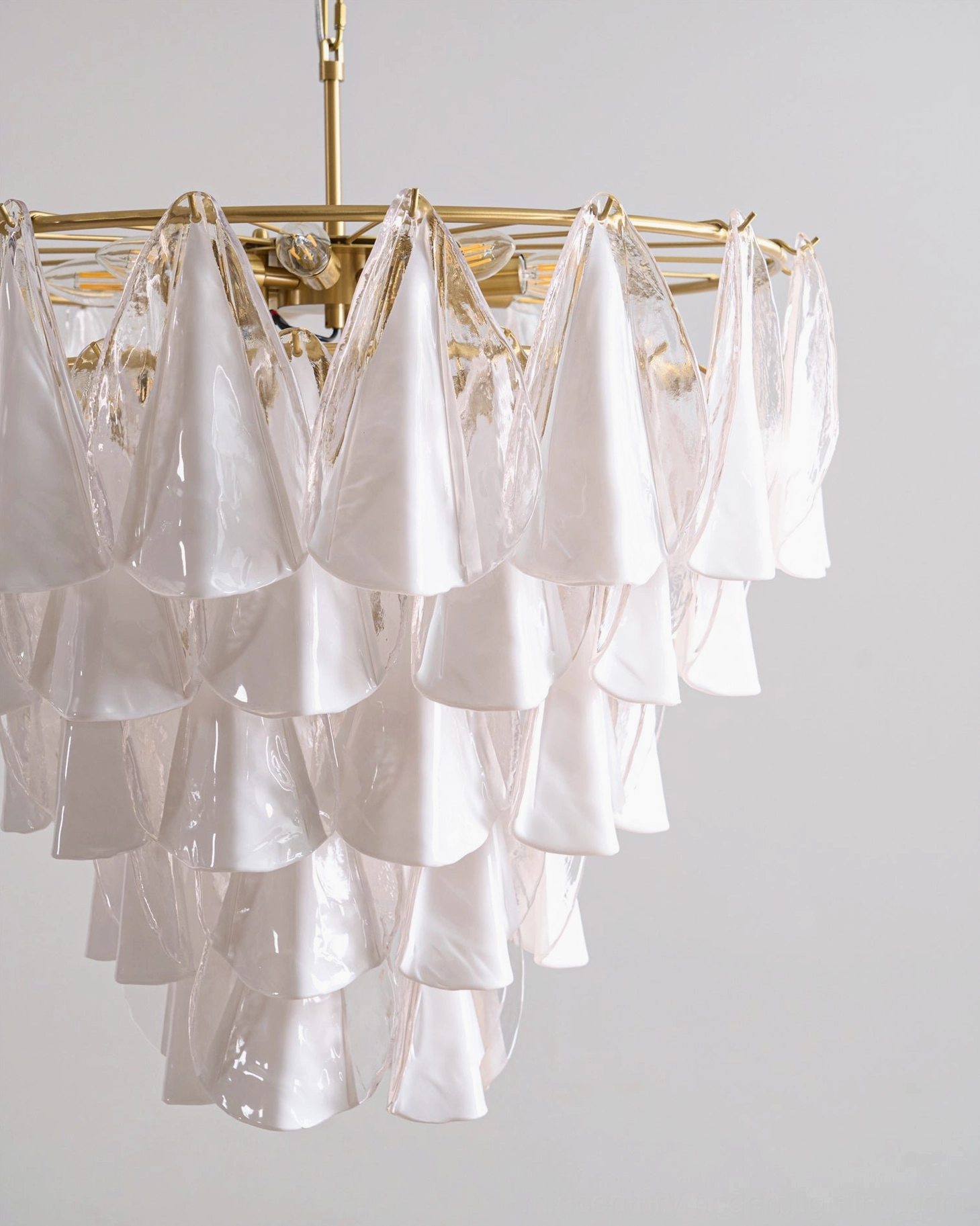 Alira tiered glass chandelier side close-up detail of dense layered glass decoration and warm brass hardware