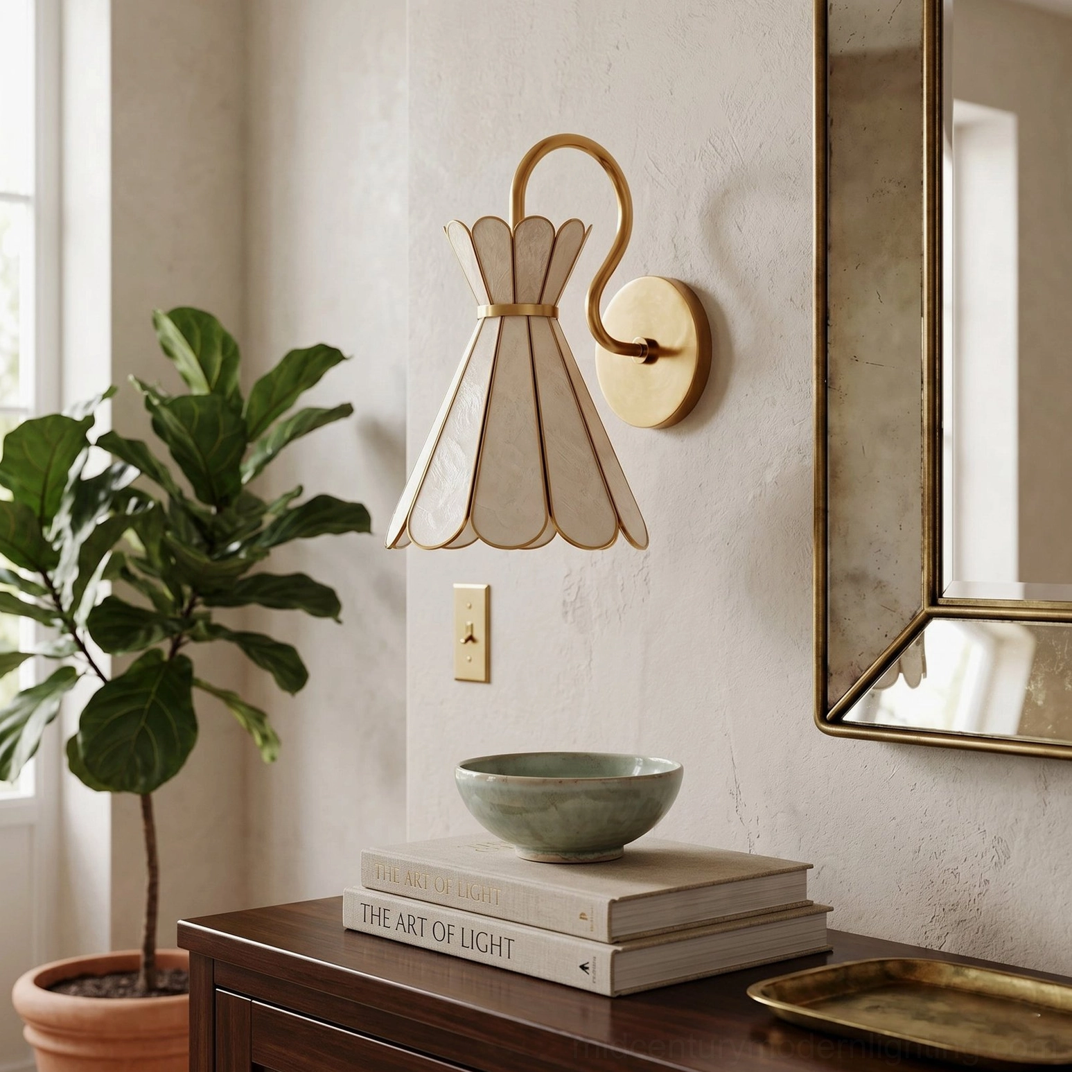 Alito sculptural wall sconce mounted in residential entryway decor scene with brass hardware and warm home accents