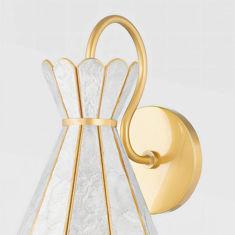 Alito wall sconce side angled view revealing curved brass wall mount bracket and scalloped petal silhouette