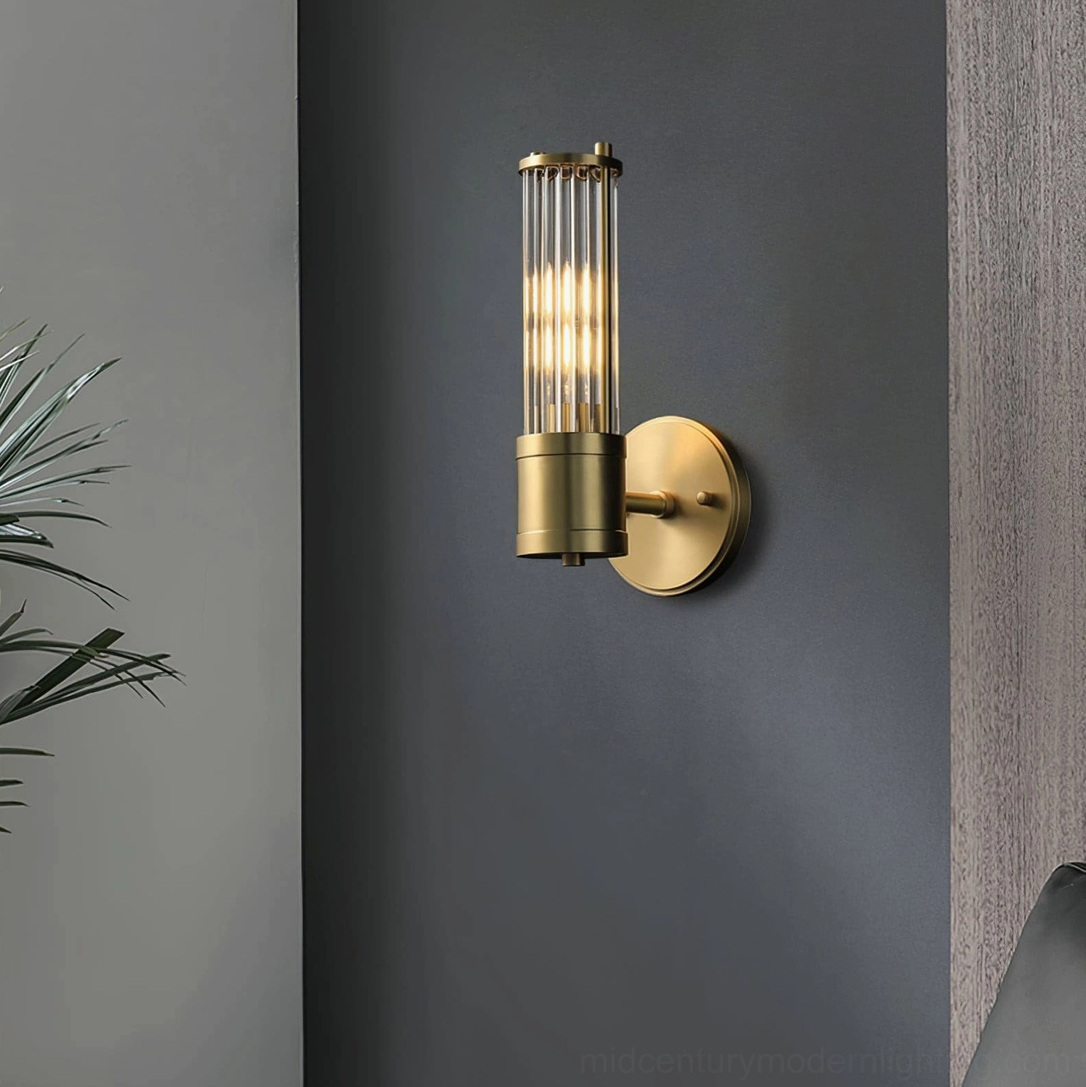 Allen brass sconce illuminated in modern living room corner architectural setting