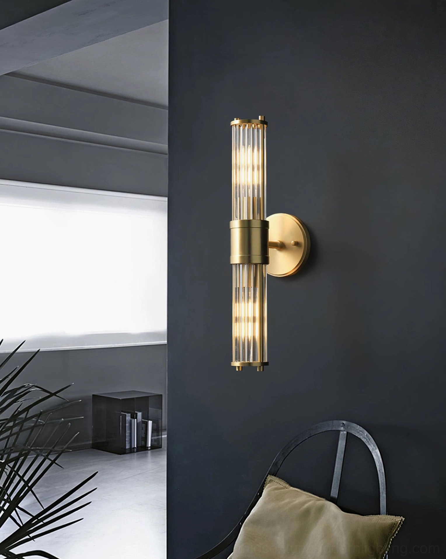 Allen brass sconce mounted on minimalist wall demonstrating contemporary styling