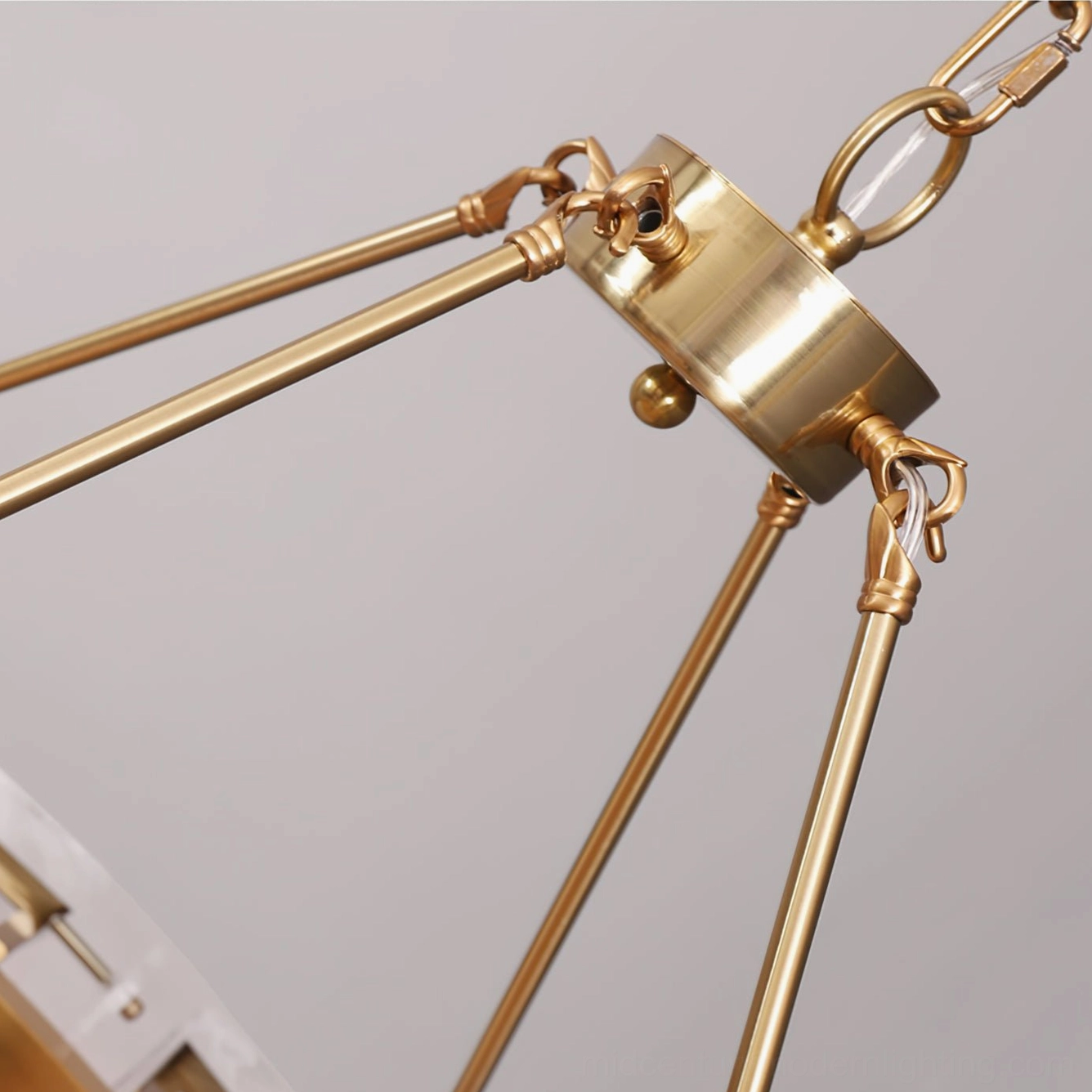 Hanging hardware and suspension chain detail of Alsona chandelier showing brushed brass metal joints and connector mechanism