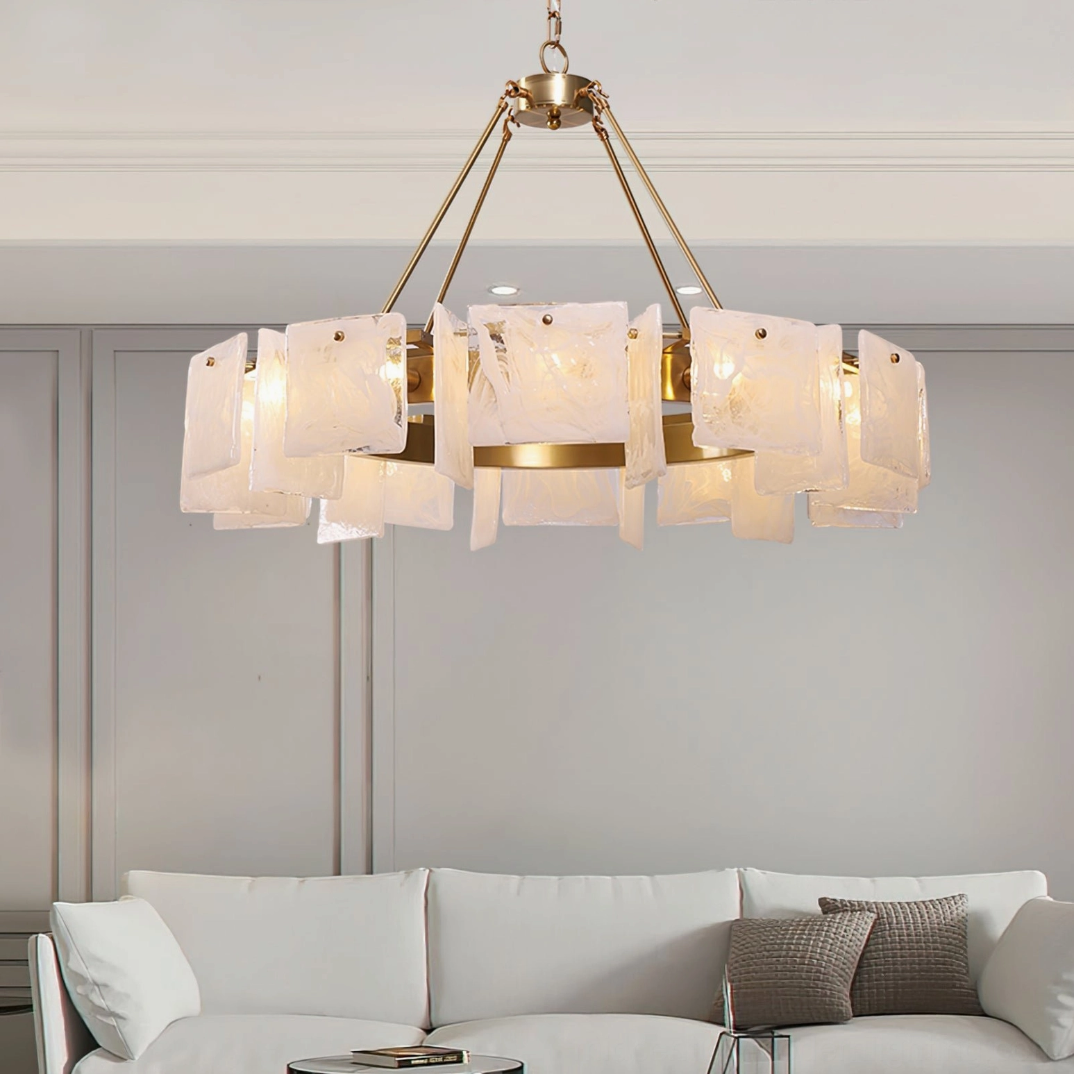 Alsona brass art glass chandelier displayed in modern living room with white sofa, showing neutral luxury home styling application