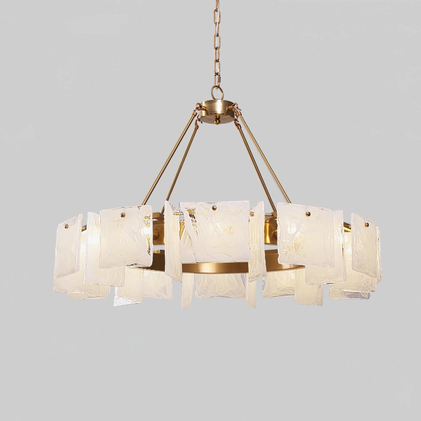 Alsona brass ring chandelier three-quarter view with illuminated glass diffusers and polished copper frame against light gray background