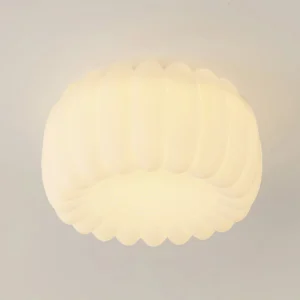 Close-up detail of Alta ceiling lamp warm white glow and textured scalloped edge design