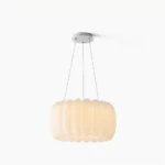 Alta organic pendant light with ribbed white plastic shade in studio setting, showing front-facing sculptural form and ceiling mount