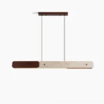 Aluet linear pendant chandelier overhead studio view showing travertine stone and walnut wood minimalist design