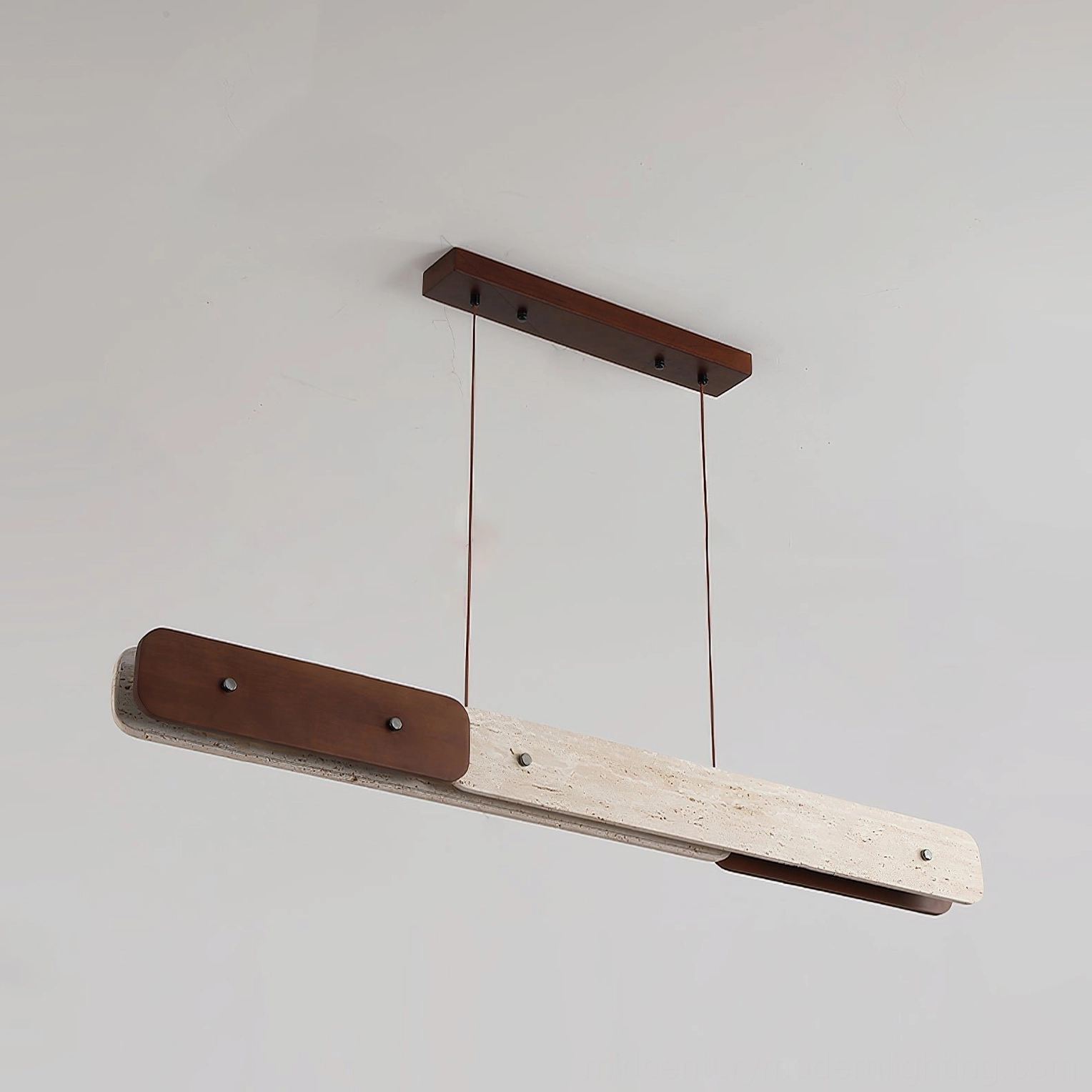 Close-up side detail of Aluet pendant showing dark walnut wood frame and travertine stone finish
