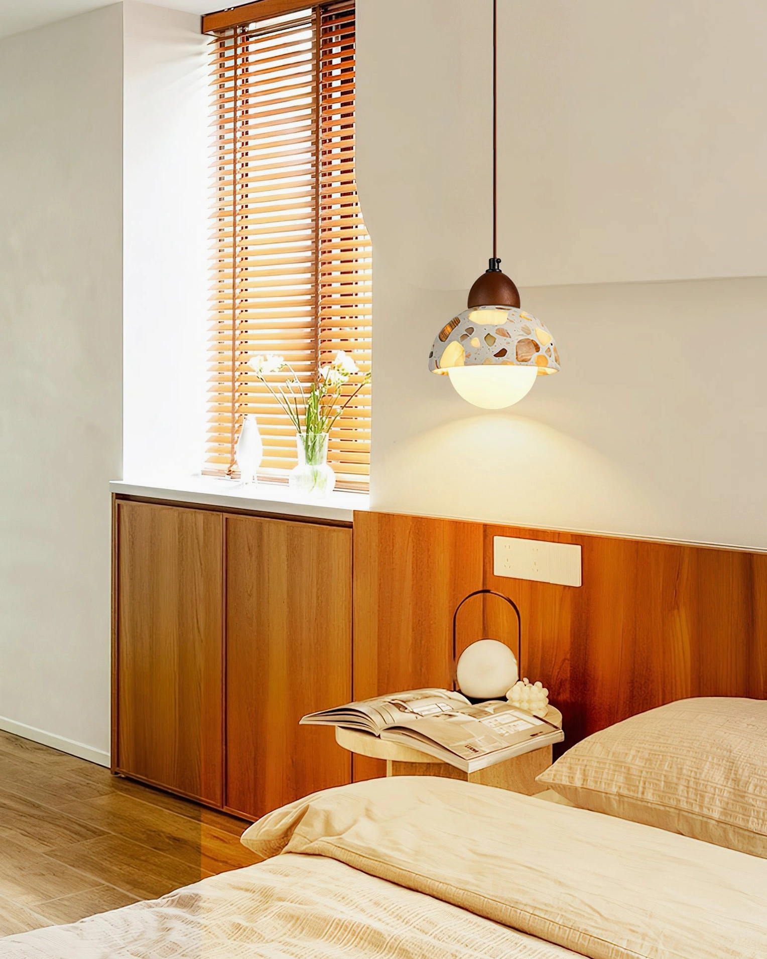 Alvaro bedside pendant lamp in bedroom with warm neutral decor and terrazzo stone shade