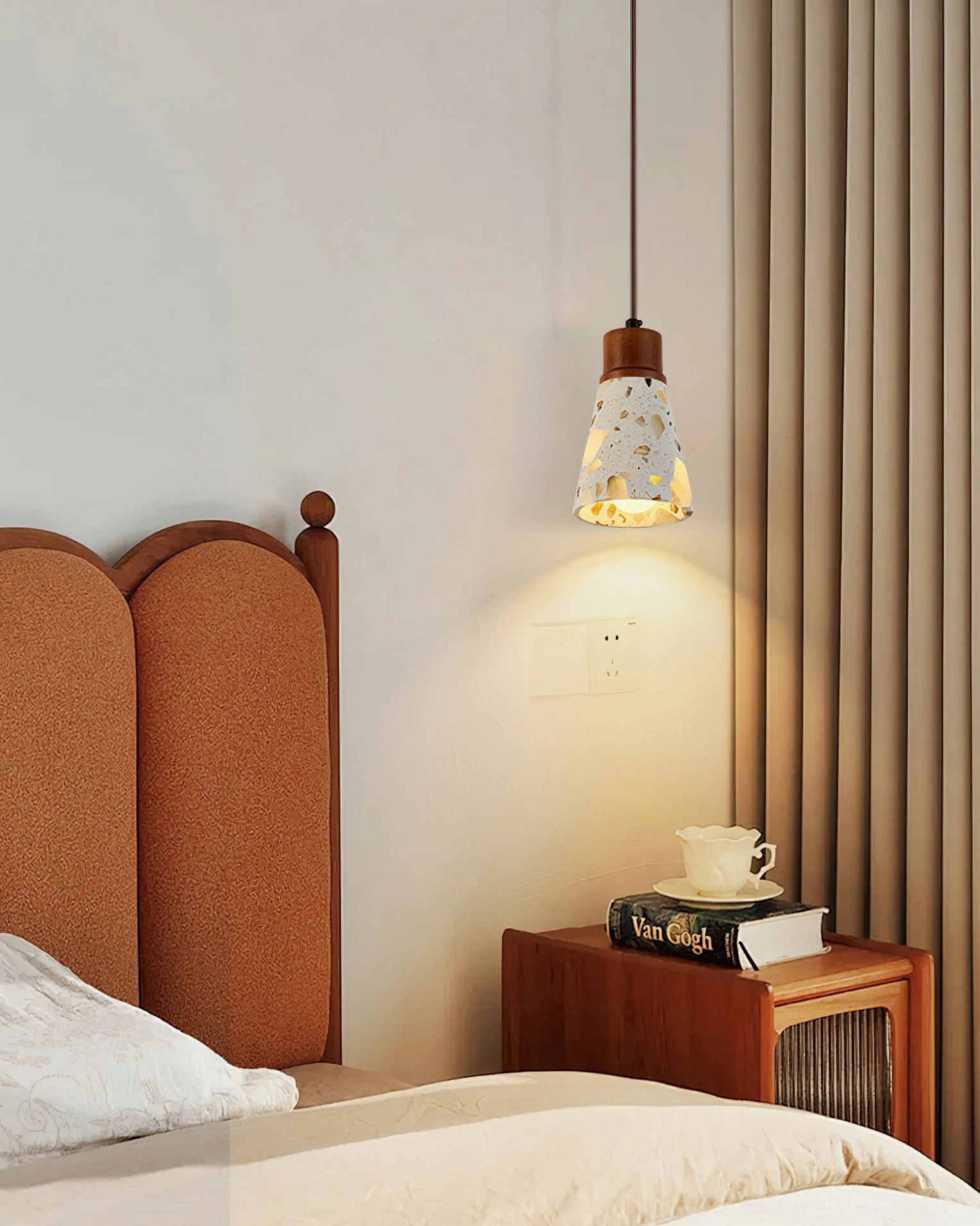 Alvaro pendant light mounted on fabric headboard wall creating warm ambient bedroom lighting