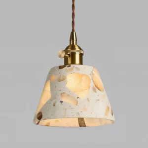 Close-up detail of Alvaro terrazzo pendant shade revealing irregular quartz fragments and luminous pattern