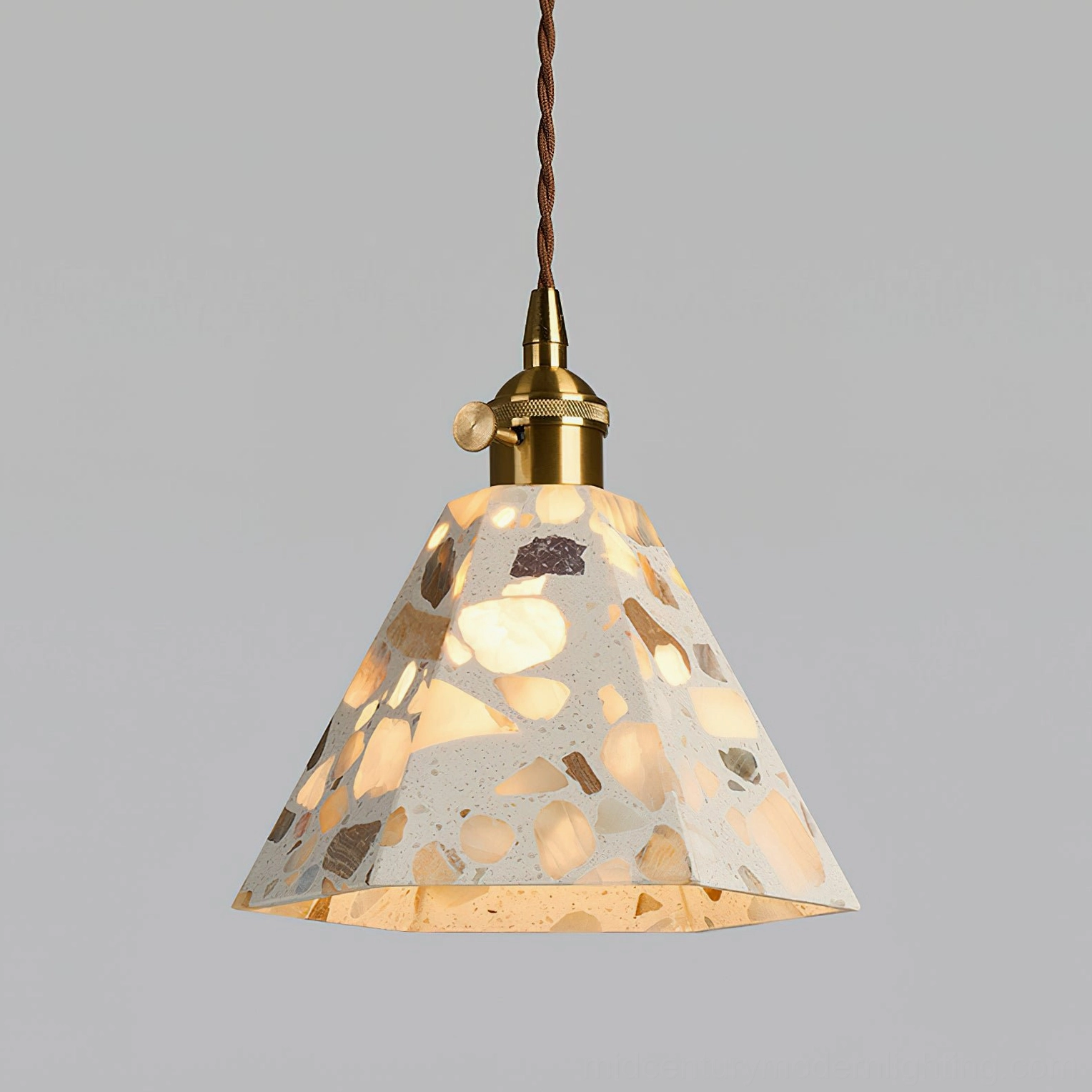 Alvaro terrazzo pendant with brass fixture details in ambient room lighting condition