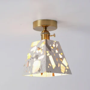 Overhead view of Alvaro mid-century modern terrazzo ceiling fixture illuminated, showing warm light diffusion through translucent stone