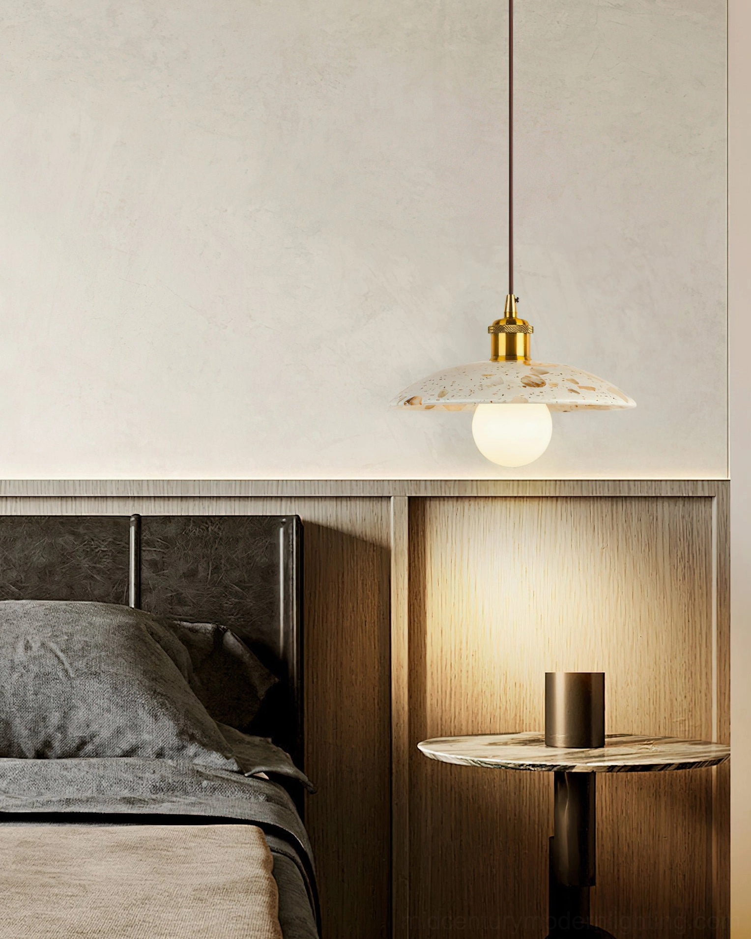 Wide flat terrazzo Alvaro pendant shade with brass hardware in dark wood bedroom panel setting