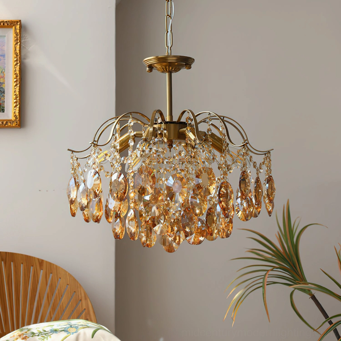 Amber crystal chandelier side view showing curved brass arms and layered crystal pendant design in home interior setting