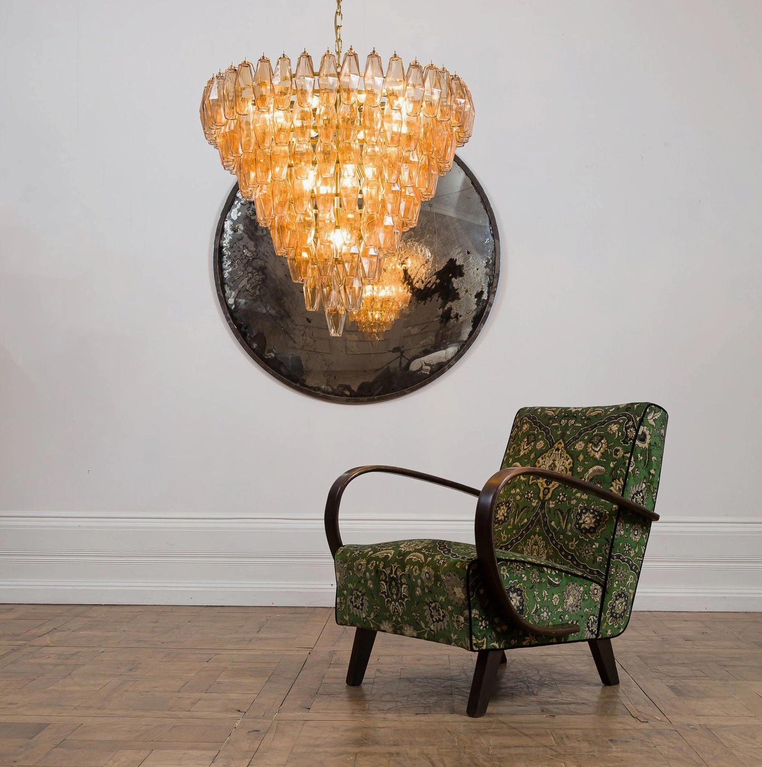 Amber tiered crystal prism chandelier in minimalist mid-century living space with armchair