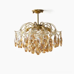 Amber crystal waterfall chandelier with brass frame, front studio view showing teardrop crystal pendants and polished metal arms