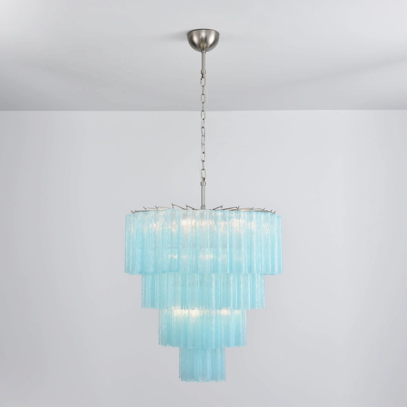 Amber glass chandelier detail shot warm luminous cascading layers architectural lighting