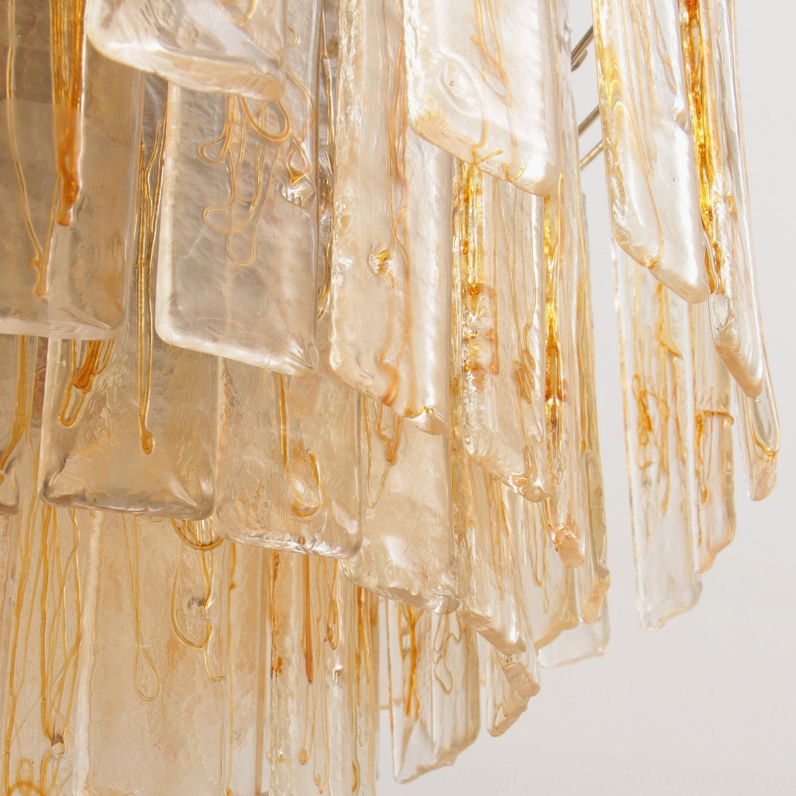 Close-up detail of amber-tinted streaked glass panels highlighting natural color variations and organic texture