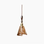 Sculptural amber glass pendant lamp with organic wavy form, dark walnut wood handle, and brass hardware on white background