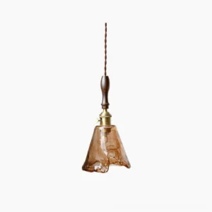 Sculptural amber glass pendant lamp with organic wavy form, dark walnut wood handle, and brass hardware on white background