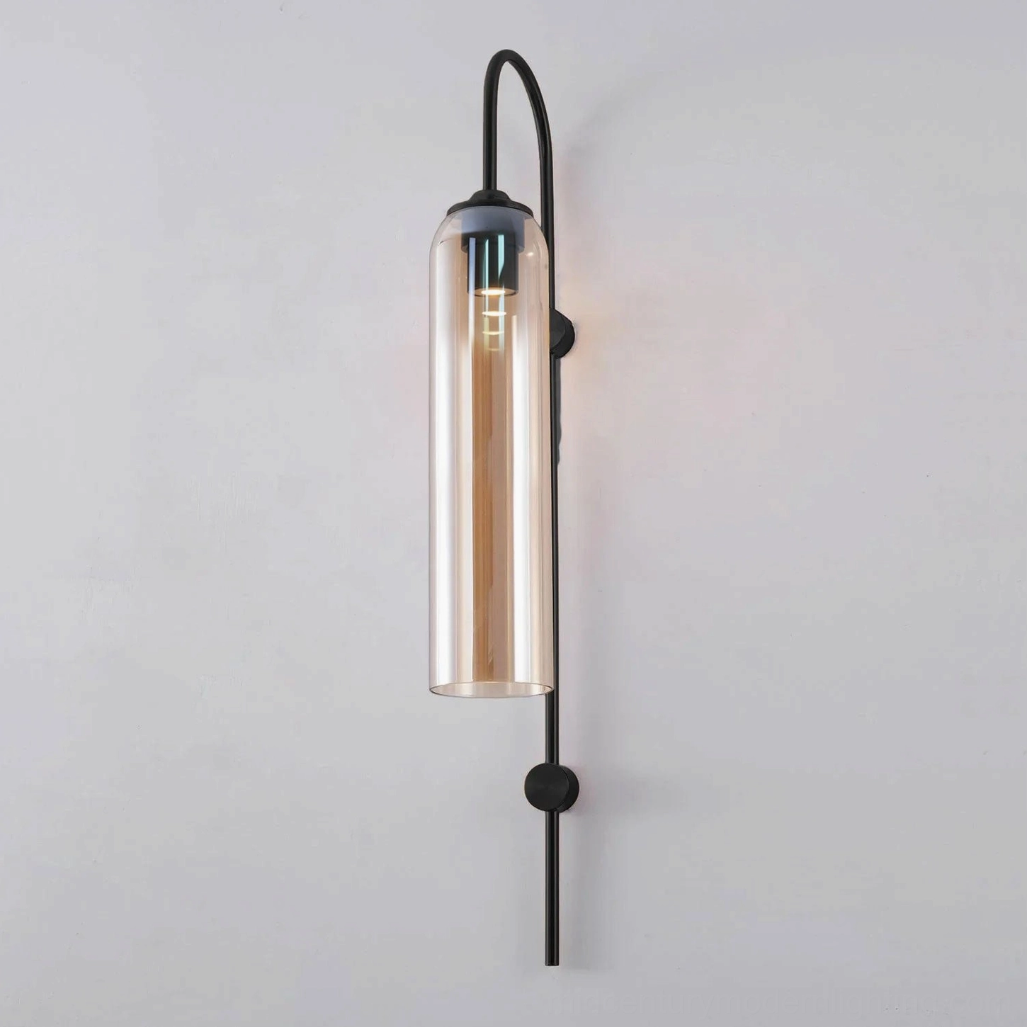 Amber-toned mouth-blown glass wall sconce creating warm nostalgic vintage cocktail lounge ambiance