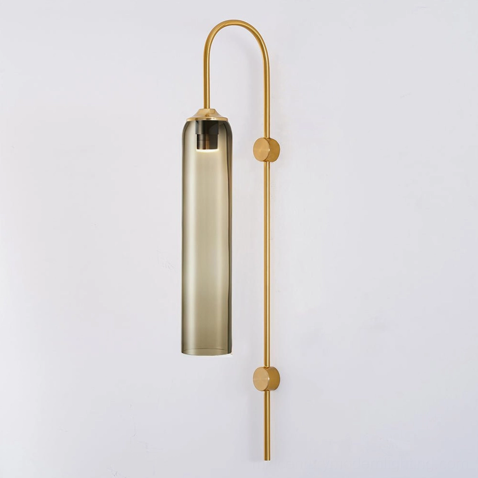 Amber glass wall sconce showing warm golden tones of mouth-blown cylindrical shade on white background