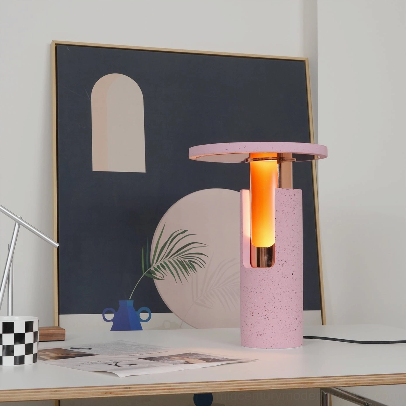 Ambra table lamp in styled home office with wall decor and plant accents