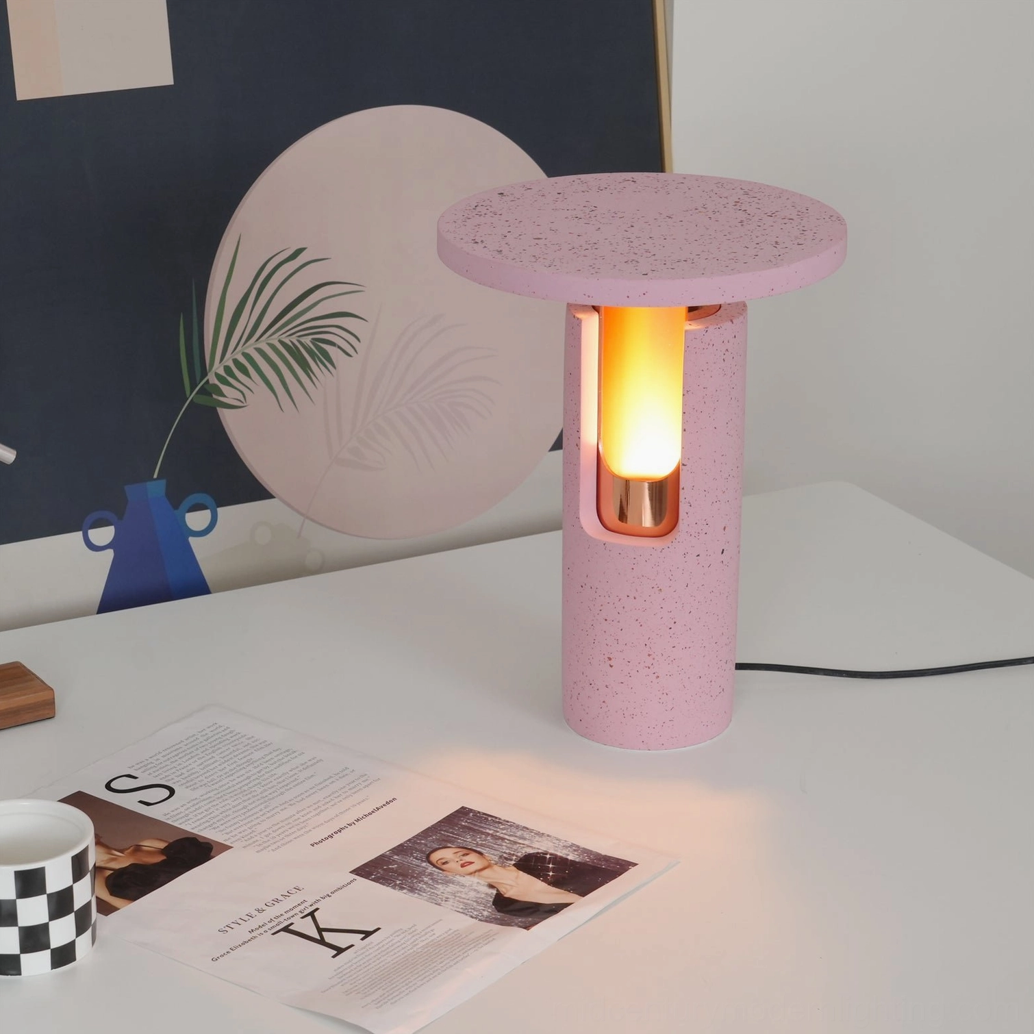 Ambra lamp illuminated warm glow pink terrazzo and rose gold contemporary aesthetic