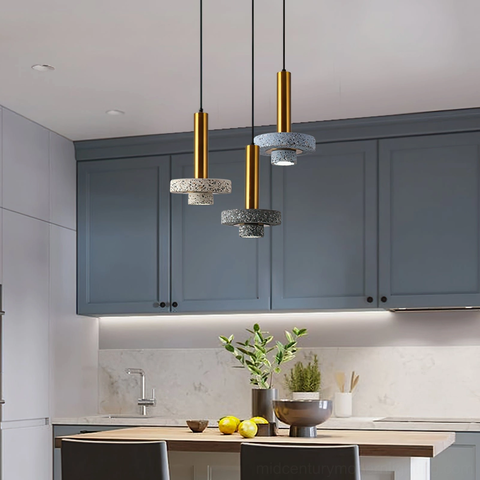 Two-tone terrazzo pendant lamps with brass hanging hardware above Nordic kitchen bar area