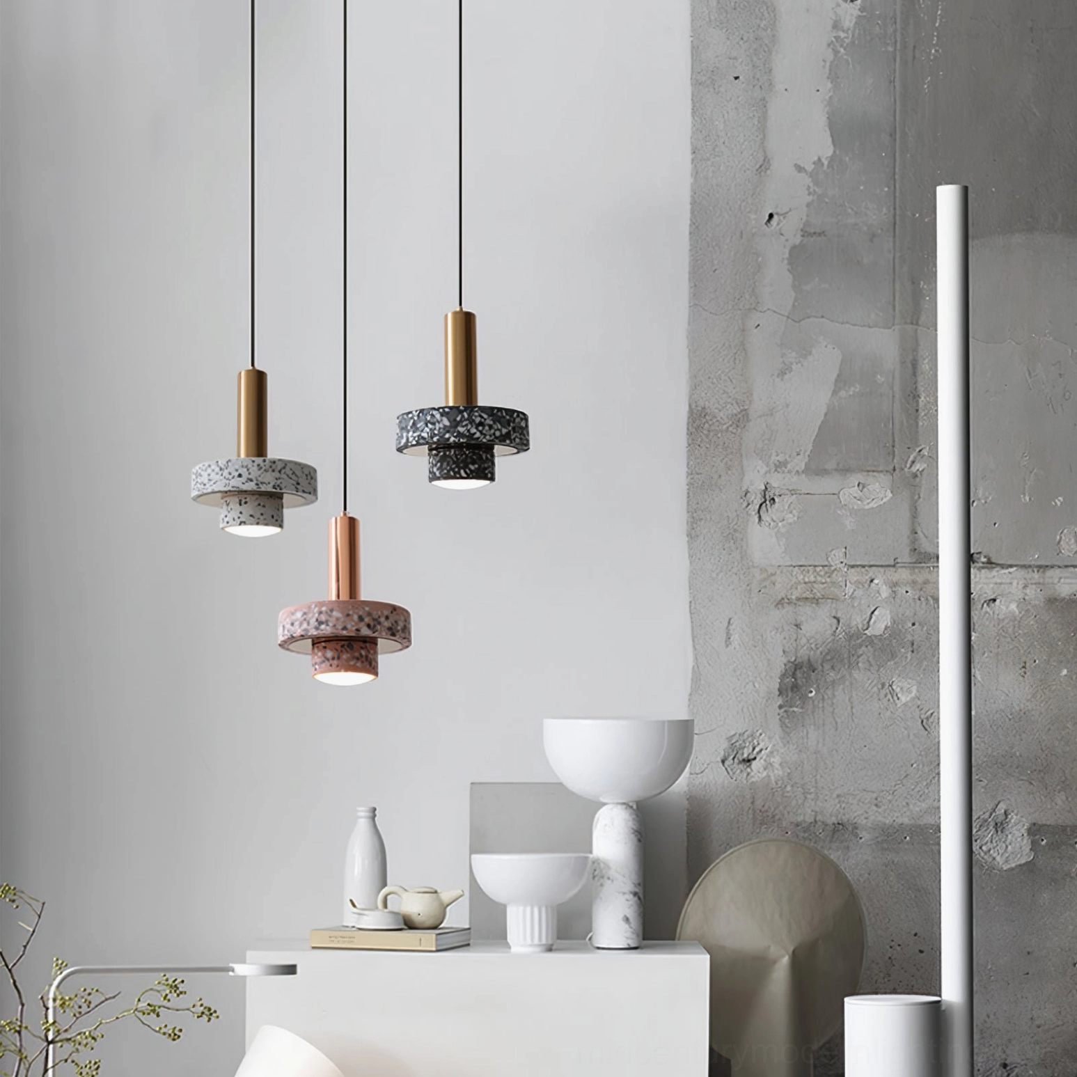 Mixed color terrazzo pendant lamps with brass metal rods in minimalist interior corner