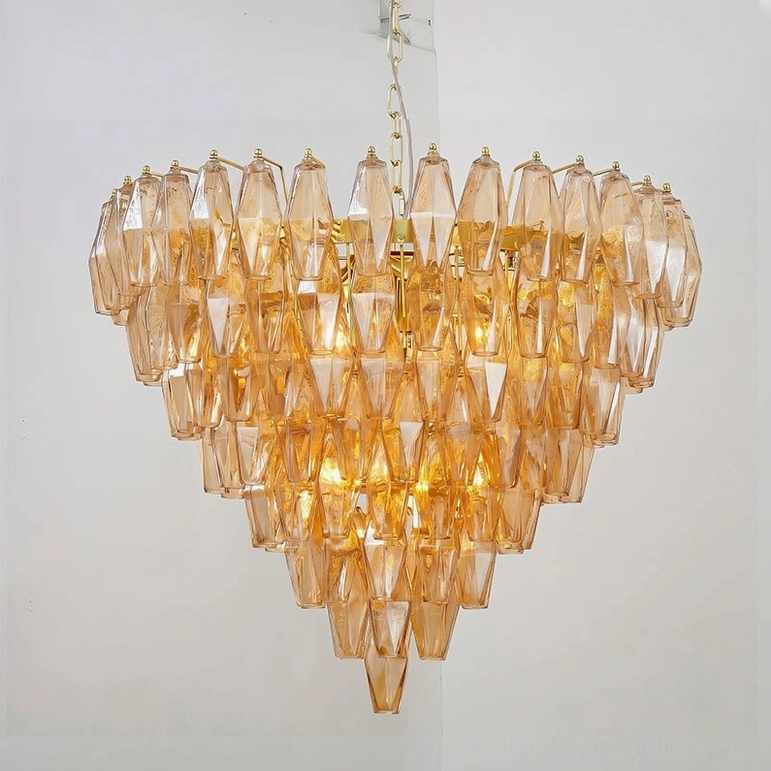 Amber and gold Ametista glass chandelier detail view showing warm orange-toned polyhedral glass with brass metal framework and hanging chain
