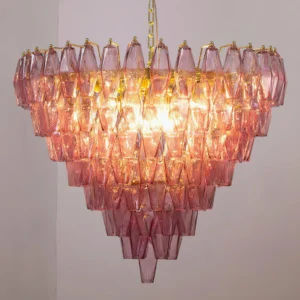 Close-up front view of Ametista glass chandelier illuminated with warm light showing intricate polyhedral glass prism details and gradient pink coloring