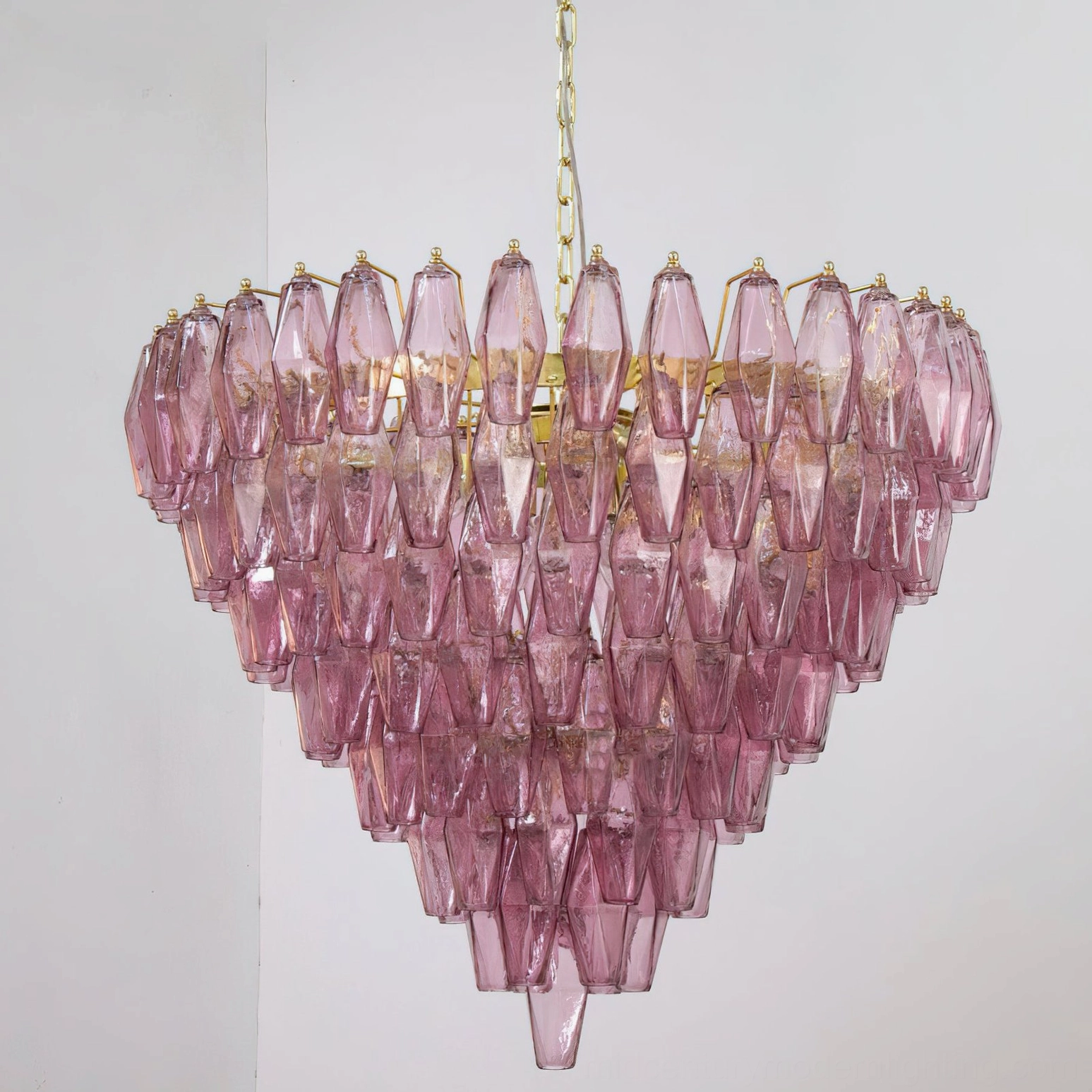 Ametista glass chandelier installed in contemporary dining room setting showing atmospheric lighting and architectural presence above table
