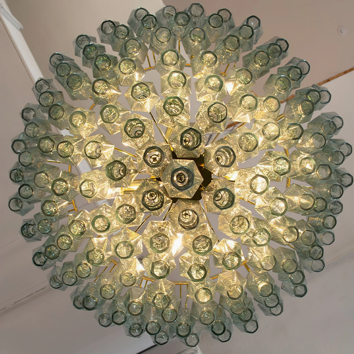 Green and gold Ametista geometric glass chandelier showing emerald-toned glass with polyhedral structure on neutral background