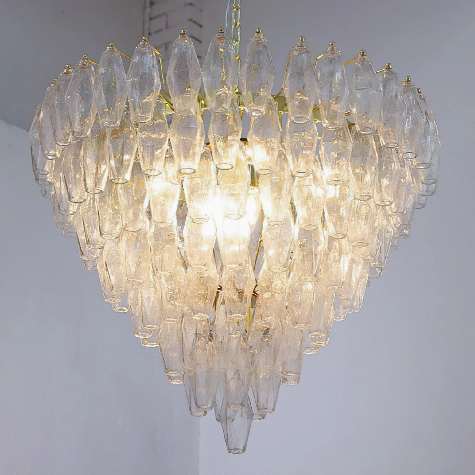 Pale yellow and gold variant of Ametista geometric glass chandelier showing warm glass coloring with polyhedral tile arrangement