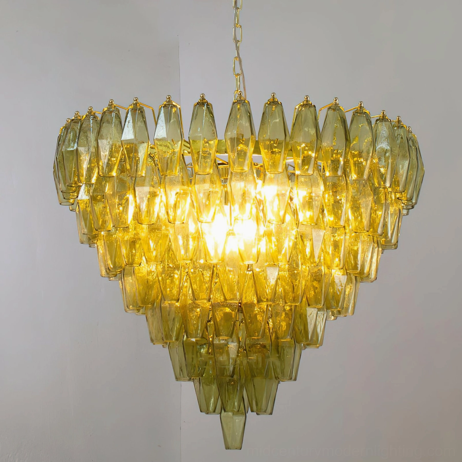 Ametista geometric glass chandelier three-quarter view highlighting polyhedral glass prism matrix and gold metal framework
