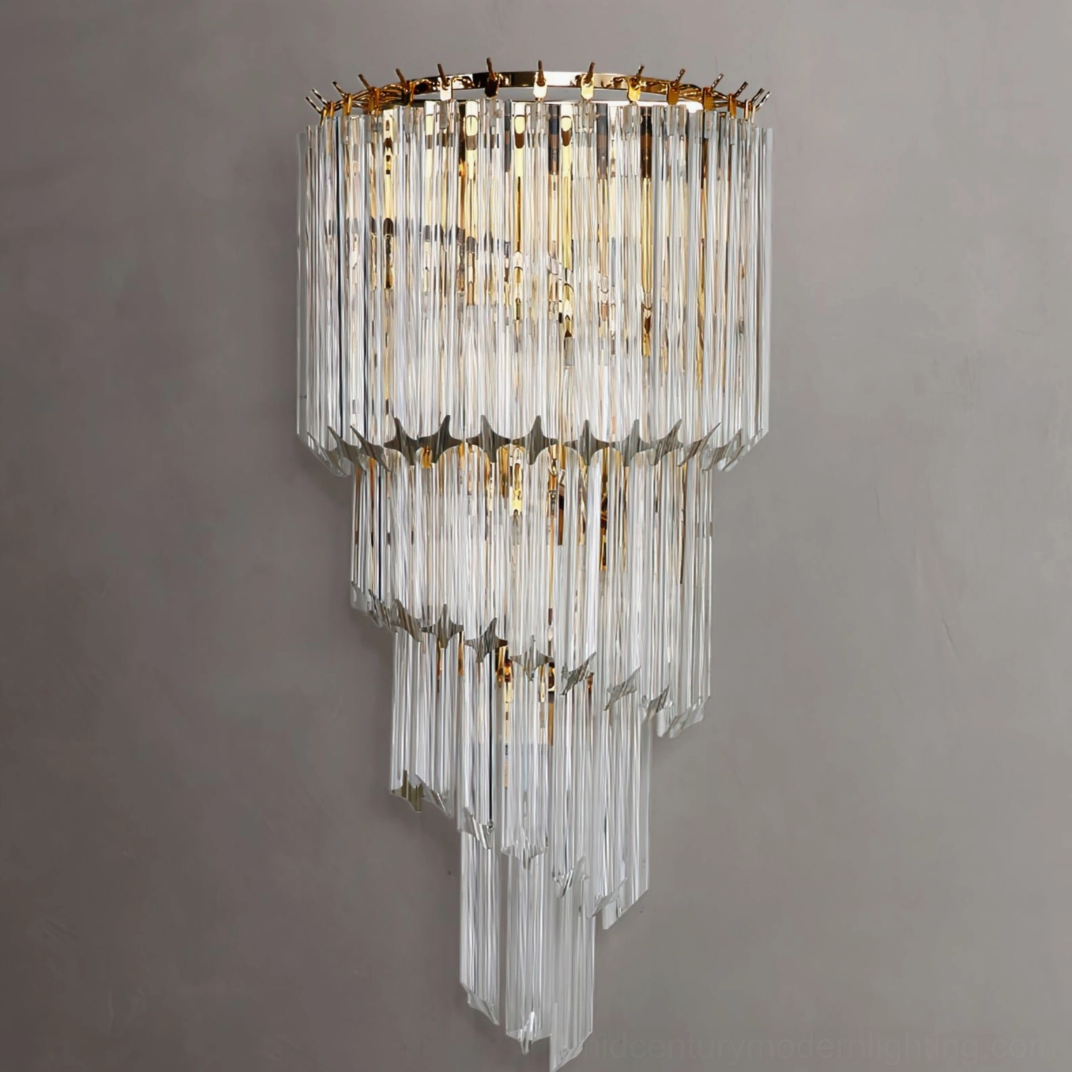 Cascading crystal wall sconce in clear finish, direct front view showcasing light refraction through tiered rods