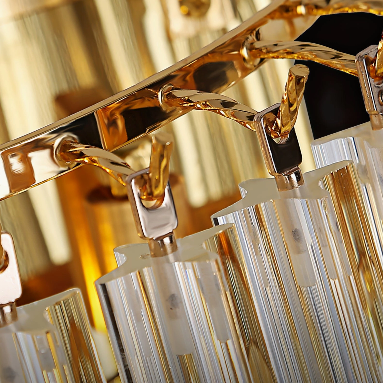 Extreme close-up of glossy gilt metal fixtures and clear crystal strips, precision engineering detail