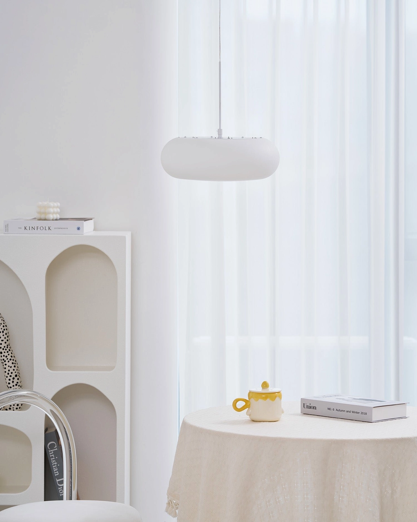 Amor minimalist white pendant lamp showing warm light diffusion and frosted glass characteristics