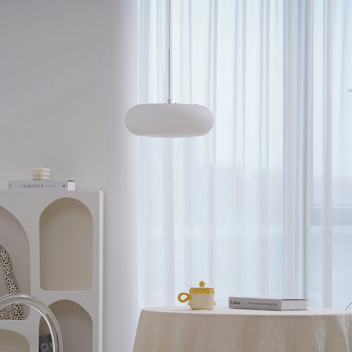 Amor white oval pendant lamp in neutral interior setting showcasing timeless mid-century modern design
