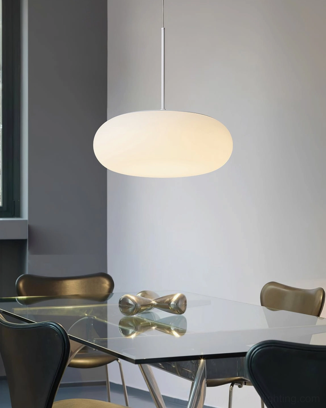 Amor pendant lamp suspended in contemporary interior space showing size proportion and warm light characteristics